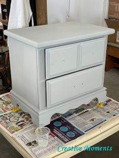 a white dresser sitting on top of a table