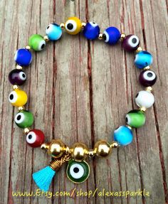 This beautifully handmade bracelet is made of round medium sized glass eye beads that are multicolors. They are made with elastic string and Multicolor 8mm Beads Evil Eye Bracelet, Multicolor Round Evil Eye Bracelets, Multicolor Evil Eye Round Bracelets, Multicolor Evil Eye Bracelet Gift, Spiritual Multicolor Round Stretch Bracelet, Adjustable Multicolor Evil Eye Bracelet With 8mm Beads, Adjustable Multicolor Evil Eye Beads, Multicolor Evil Eye Bracelets, Adjustable Evil Eye Bracelet With Colorful Beads