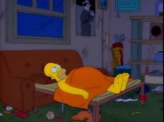 the simpsons is laying down in his living room