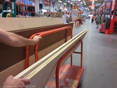 a man is working on some furniture in a store