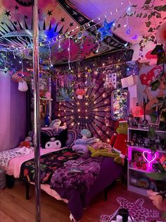 a bedroom decorated in purple and pink with lots of lights on the ceiling, bedding and decorations