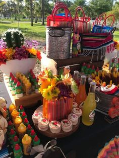 a table topped with lots of different types of food and drink bottles on top of it