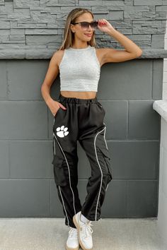 Make a bold statement with our Clemson Tigers Low Waist Parachute Cargo Pants featuring your team's logo. These trendy, relaxed-fit pants combine utility with style, offering multiple pockets and a lightweight design. Perfect for game days or casual wear, they let you rep your team with an edgy, streetwear-inspired look. Madi Prewett, Parachute Cargo Pants, Parachute Cargo, Edgy Streetwear, Gameday Couture, Nebraska Cornhuskers, North Carolina Tar Heels, Oklahoma Sooners, Florida State Seminoles