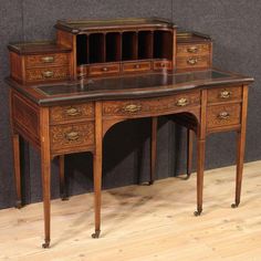 an antique wooden desk with drawers on it