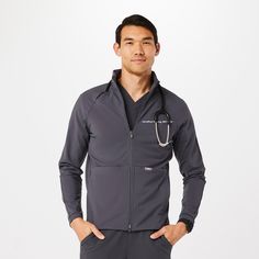 Official FIGS® Outerwear. Get Free Shipping On Orders $50+! | FIGS Mens Charcoal ContourKnit Scrub Jacket™ Fitted Functional Track Jacket With Pockets, Gray Long Sleeve Activewear With Pockets, Fitted Track Jacket For Workwear In Athleisure Style, Gray Long Sleeve Athleisure Outerwear, Functional Long Sleeve Relaxed Fit Track Jacket, Scrub Jackets, Shell Jacket, Fig, Vest Jacket