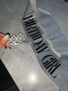 a person holding a tiara in their hand