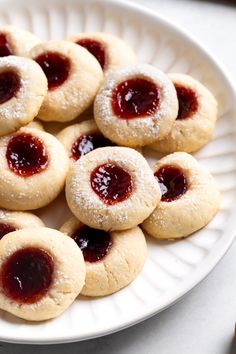 This recipe for one-bowl cream cheese thumbprint cookies features such simple ingredients, but the taste is anything but! An easy, quick-chilling dough bakes up perfectly tender and soft with a pool of raspberry jam in the center. They're a family favorite holiday cookie. Thumbprint Cookies Sallys Baking, Christmas Baking Thumbprint Cookies, Thumb Print Cookies With Cream Cheese, Thumbprint Cheesecake Cookies, Raspberry Cream Cheese Thumbprints, Cream Cheese Thumb Print Cookies Recipes, Cheesy Thumbprint Cookies, Ina Garten Thumbprint Cookies, Apricot Jam Cookies Recipe