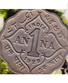 a close up of a coin on a table with trees in the backgroud