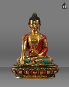 a golden buddha statue sitting on top of a table