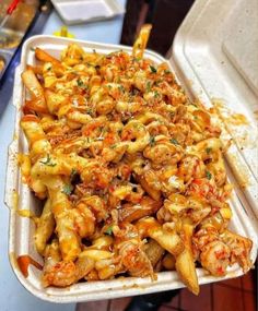 a white tray filled with pasta covered in sauce