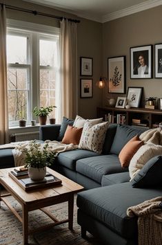 a living room filled with lots of furniture and pictures on the wall next to a window