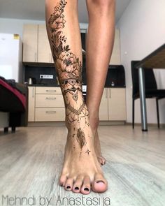 a woman's legs with tattoos on them