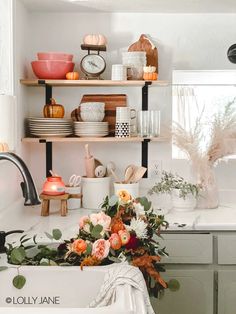 a kitchen filled with lots of dishes and flowers