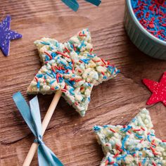 two star shaped treats on sticks with sprinkles