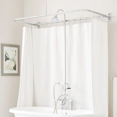 a white bath tub sitting next to a shower curtain