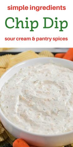 a white bowl filled with dip surrounded by carrots and crackers