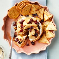 a plate with crackers and fruit on it