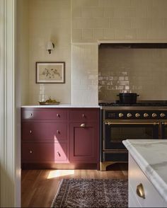 a kitchen with an oven, sink and counter top in the middle of the room