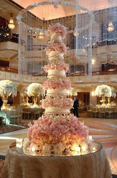 a large wedding cake is in the middle of a room