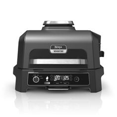 an image of a black and silver grill with the timer on it's side