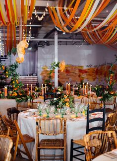 the tables are set for an event with orange streamers