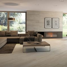 a modern living room with wood flooring and large windows