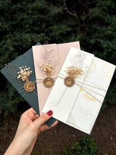 three handmade greeting cards, one with flowers and the other with gold foil on them