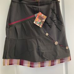 This Intricate Design Skirt Is One Of A Kind. Skirt Has A Stripe Fabric Lining The Bottom Half, Three Decorative Buttons And Decorative Exposed Zipper Makes Part Of The Front Design, Has A Side Zipper. Some Words Written On Skirt That I Can’t Translate Smoke Free House Pet Free House Color Looks Like Charcoal Or Dark Gray Scottish Skirt, A Line Skirt Midi, Gold Mini Skirt, Design Skirt, Athletic Skirts, Skirt Coverup, Clothing Pieces, House Color, Beautiful Skirt