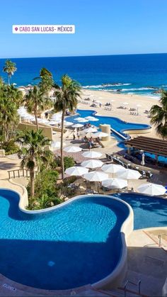 an aerial view of a resort pool and beach