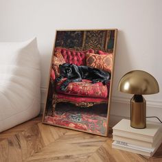 a black dog laying on top of a red couch next to a lamp and pillows