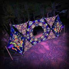 an illuminated tent in the woods at night