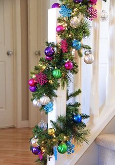 christmas decorations are hanging on the banister