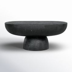 a black object sitting on top of a white surface