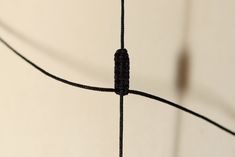 a close up view of a wire with a black object in the middle on it