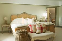 a bedroom with a large bed and wicker furniture