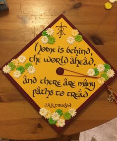 a graduation cap with flowers on it that says, done is being the world ahead and there are many paths to reach