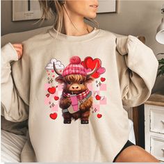 If you're looking for a unique and adorable Valentine's Day gift, look no further than our boujee highland cow graphic T-shirt, sweater, or hoodie! Made from high-quality materials, this comfortable and stylish piece of clothing features a cute and trendy graphic of a highland cow, perfect for showing off your love of animals and fashion sense. Whether you're dressing up for a romantic dinner or just hanging out with friends, this Valentine's Day T-shirt, sweater, or hoodie is sure to make a sta Valentine's Day Casual Hoodie With Letter Print, Valentine's Day Casual Long Sleeve Sweatshirt, Casual Long Sleeve Sweatshirt For Valentine's Day, Highland Cow Valentine, Cow Valentine, Valentine Hoodie, Cow Graphic, Valentine Sweatshirt, Cow Shirt