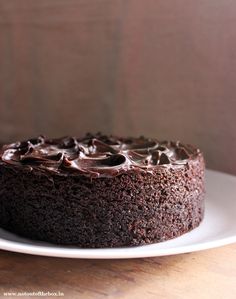 a chocolate cake sitting on top of a white plate