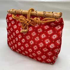 This listing is for a vintage Japanese kinchaku (drawstring) purse. These are a prized accessory for a kimono-clad woman even today. They're typically made with kimono fabric, have a flat base, and tend to be used for casual, rather than formal, occasions. This bag is rectangular with a yellow cording drawstring and bamboo rosa at the top closure. The cording extends to go over the top of the bamboo and loop around a smaller bamboo button. The fabric is a red with a grid of shibori diamonds. Lined. Excellent condition. Length: 9" Width: 3" Made In (Estimated): 1960s Condition: Excellent Fiber: Rayon Technique: Shibori, Woven Colors: Red, White, Yellow Motifs: Geometric Japanese Kimono Purse, Kimono Traditional, Drawstring Purse, Kimono Fabric, Drawstring Pouch, Coin Purses, Purse Pouch, Over The Top, Pouch Bag