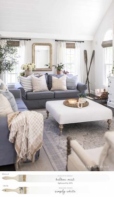 a living room filled with lots of furniture and flowers on top of a coffee table