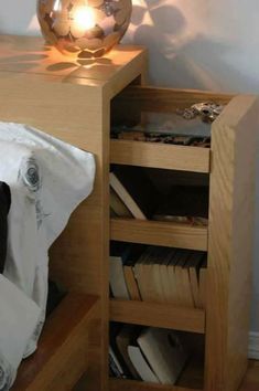 a lamp that is sitting on top of a wooden table next to a book shelf