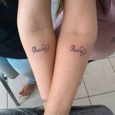 two girls with matching tattoos on their arms that read china and one has the word china written in cursive letters