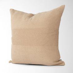 a beige pillow on a white background