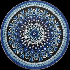 a blue and black plate with an intricate design