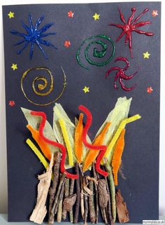 an art project made out of sticks and colored thread on a black board with stars