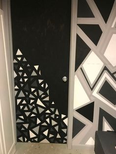 the door is decorated with black and white geometric designs on it's side wall