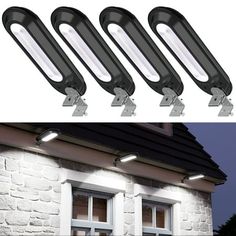 four lights that are on the side of a building and one is in front of a window