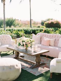 a living room filled with furniture and flowers