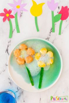 the flowers are made out of foam and water in a bowl with soap on top