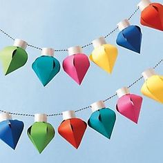 colorful paper hearts are hanging on a string